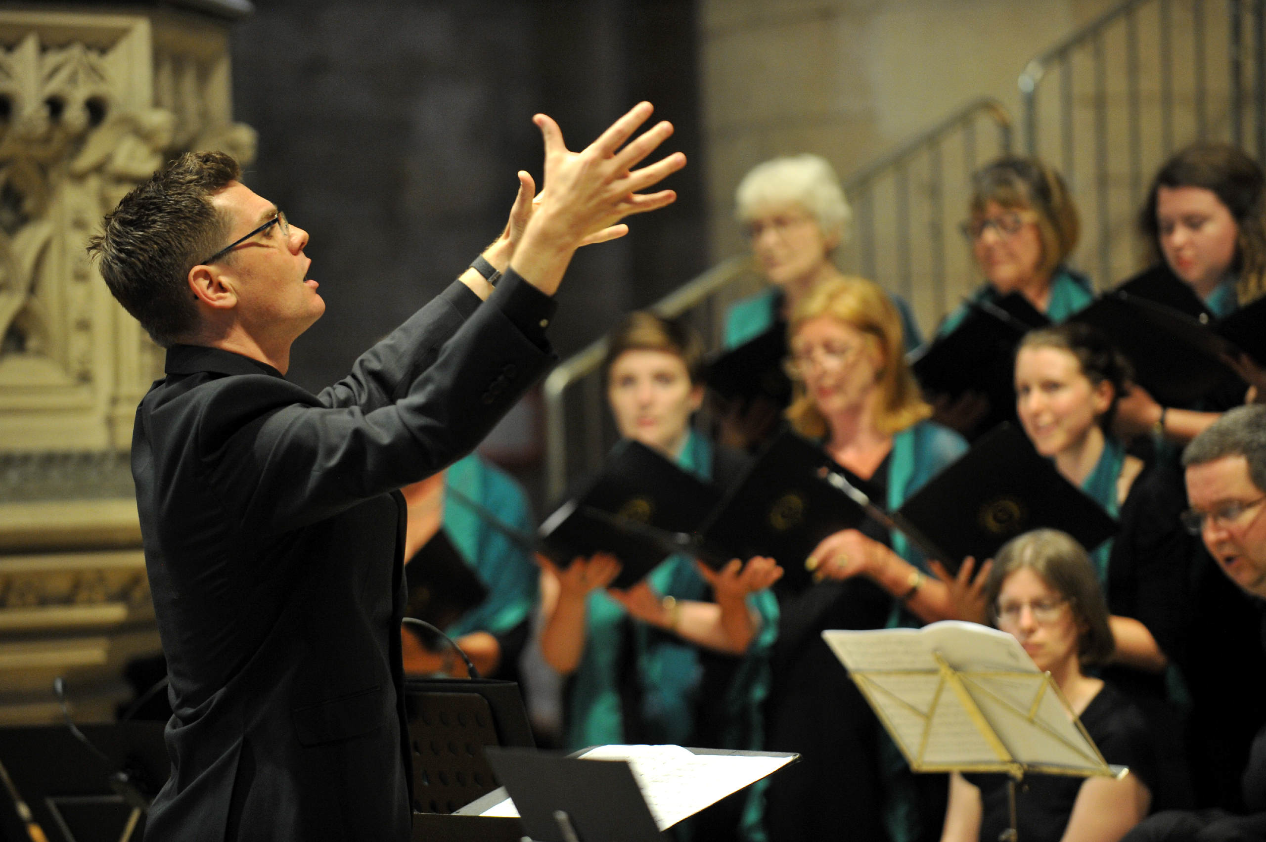 The choir singing as musical director Ben Sawyer conducts